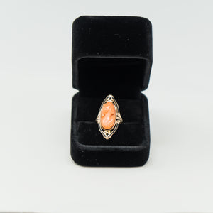 an orange ring in a black velvet box