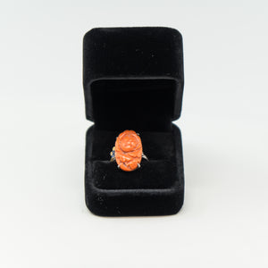 an orange ring in a black velvet box